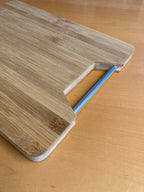 Bamboo cutting board with metal handle (32.5 x 25 x 1.8 cm)