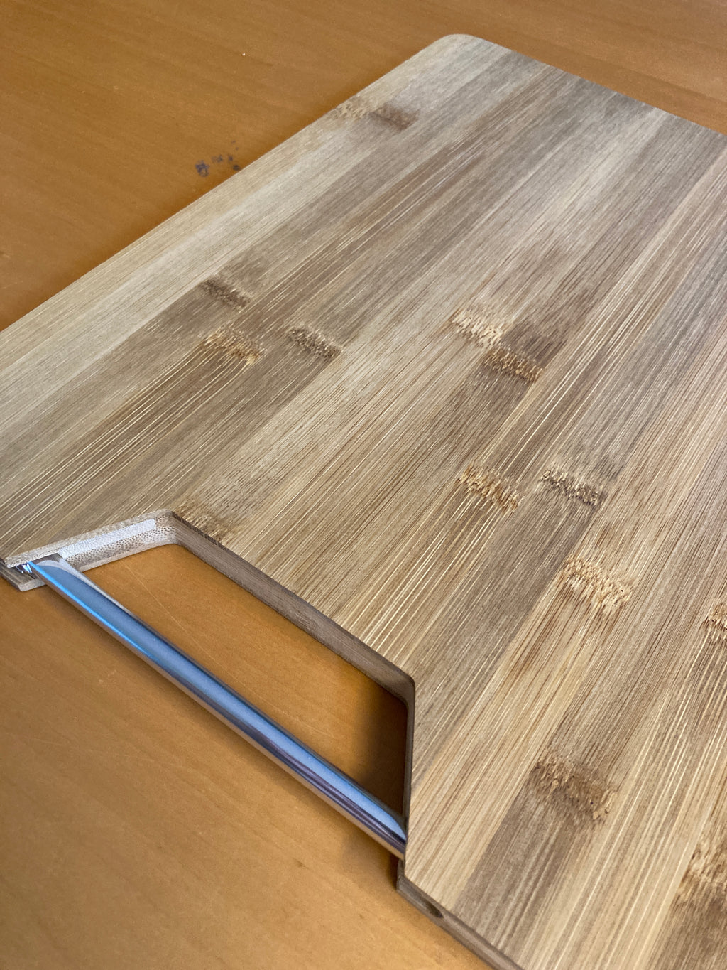 Bamboo cutting board with metal handle (32.5 x 25 x 1.8 cm)